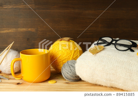 Concept of knitting with yarn balls on wooden table Concept of knitting with yarn balls on wooden table 89415885