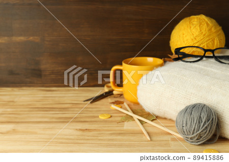 Concept of knitting with yarn balls on wooden table Concept of knitting with yarn balls on wooden table 89415886