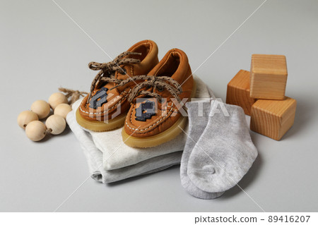 Concept of male baby clothes on light gray background Concept of male baby clothes on light gray background 89416207