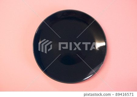 Navy blue plate and pink background 89416571