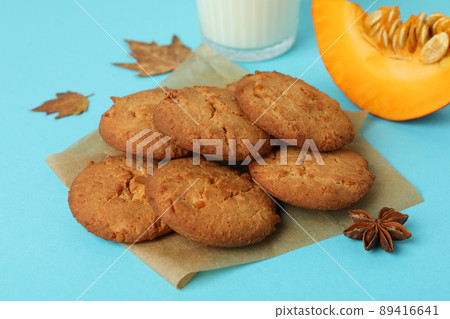 Milk and pumpkin cookies on blue background 89416641