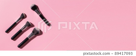 Various make-up brushes on pink background, top view banner and place for advertising - Cosmetics and beauty concept. 89417093