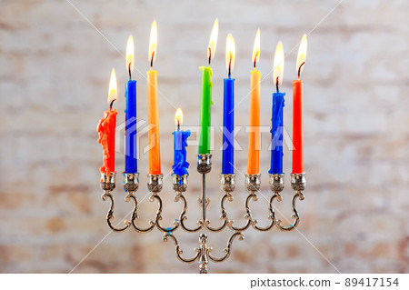 Jewish holiday Menorah Beautiful with burning candles on light blurred background. Jewish holiday Menorah Beautiful with burning candles on light blurred background. 89417154