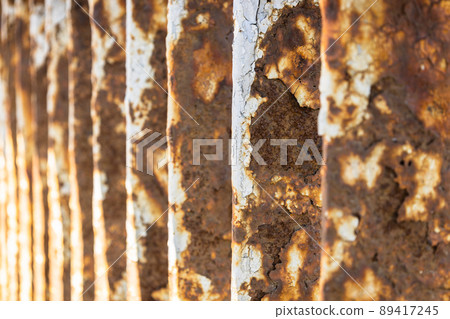 Rusty bridge railing texture background with cracked white paint Rusty bridge railing texture background with cracked white paint 89417245