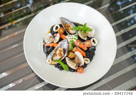 Italian Riso Pasta Tossed in Black Squid Ink & Topped With Shrimps & Mixed Seafood 89417248