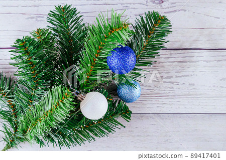 Christmas or New Year background: fur-tree, branches, colored glass balls and toys, gifts, decoration on a white Christmas or New Year background: fur-tree, branches, colored glass balls and toys, gifts, decoration on a white 89417401