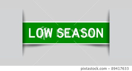Inserted green color label sticker with word low season on gray background Inserted green color label sticker with word low season on gray background 89417633