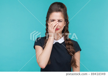 Unhappy woman cry and have sadness look. Indoor, studio shot on blue background Unhappy woman cry and have sadness look. Indoor, studio shot on blue background 89418349