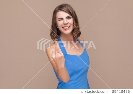 Crazy happiness woman showing fuck sign but not seriously. Indoor shot Crazy happiness woman showing fuck sign but not seriously. Indoor shot 89418456