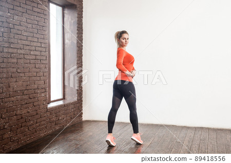 Sport, fitness concept. Woman in sportswear showing her sporty ass. Studio shot Sport, fitness concept. Woman in sportswear showing her sporty ass. Studio shot 89418556