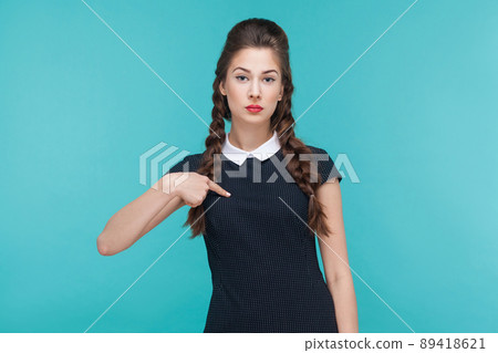 Seriously arrogant businesswoman pointing finger himself, looking at camera. Studio shots Seriously arrogant businesswoman pointing finger himself, looking at camera. Studio shots 89418621