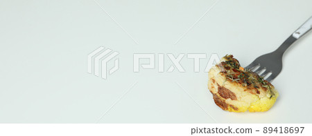 Fork with baked cauliflower on white background 89418697