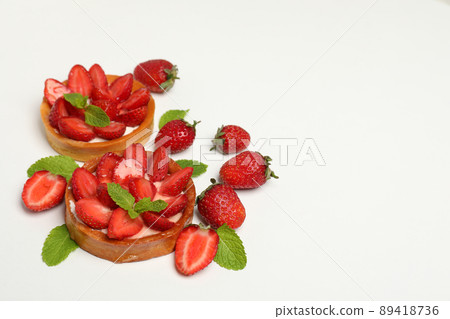 Delicious strawberry tarts on white background, space for text Delicious strawberry tarts on white background, space for text 89418736