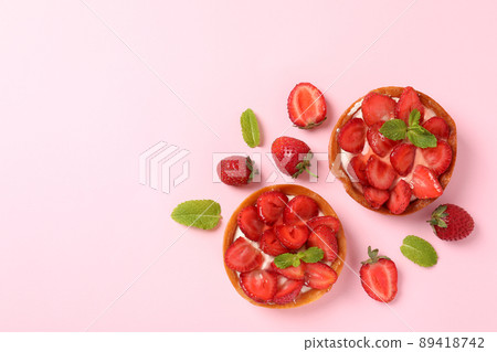Strawberry tarts on pink background, space for text 89418742