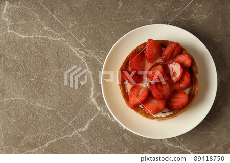 Plate with strawberry tart on gray textured table Plate with strawberry tart on gray textured table 89418750