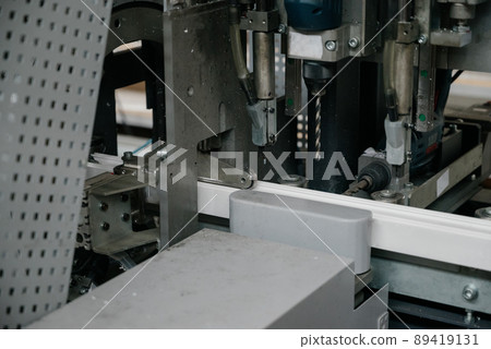 Factory for aluminum and PVC windows and doors production. Details industrial equipment. Factory for aluminum and PVC windows and doors production. Details industrial equipment. 89419131
