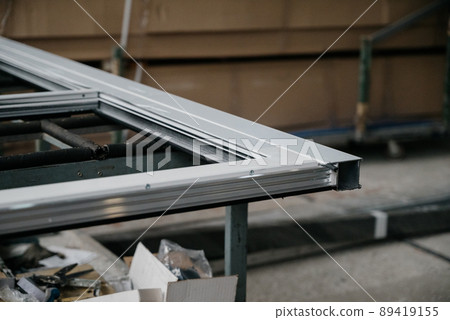Production and manufacture of window profiles. Plastic and metal profiles close-up Production and manufacture of window profiles. Plastic and metal profiles close-up 89419155