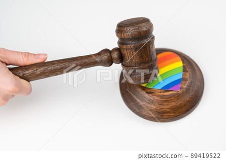 The judge hits a heart with a rainbow flag with a gavel. 89419522