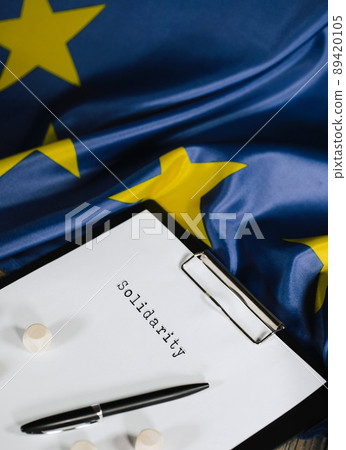 Word SOLIDARITY is written on the paper. EU Flag. Closeup Word SOLIDARITY is written on the paper. EU Flag. Closeup 89420105
