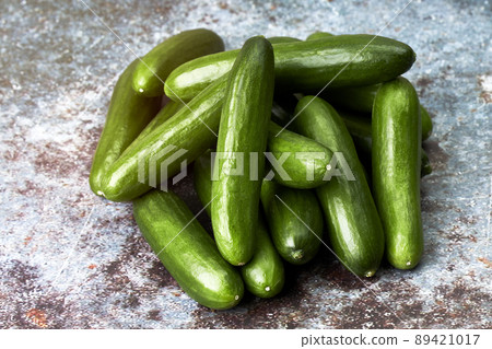 Pile of healthy and ecological baby cucumbers. Vegan and vegetarian food Pile of healthy and ecological baby cucumbers. Vegan and vegetarian food 89421017
