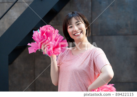 A woman practicing cheerleading 89422115
