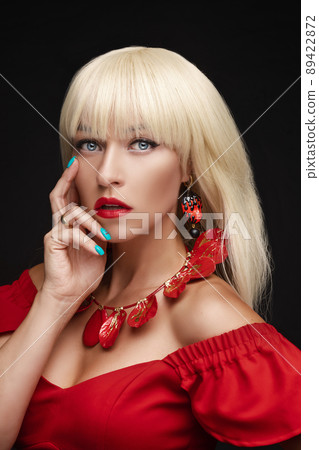 Gorgeous woman with blonde hair in red. 89422872