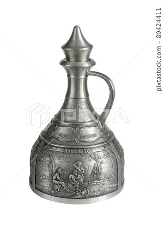 Vintage pewter decanter isolated on a white background. Vintage pewter decanter isolated on a white background. 89424411