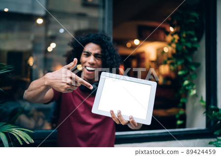 Blurred male blogger showing gadget notification for app Blurred male blogger showing gadget notification for app 89424459