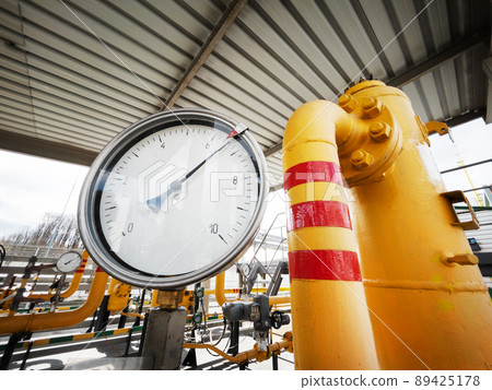 Yellow gas pipeline with a large pressure gauge for measuring gas pressure 89425178