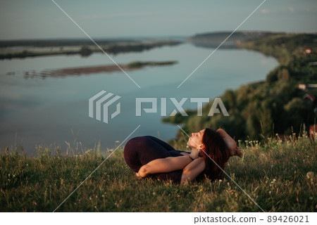 Yoga practice and meditation outdoor. Girl in the park 89426021