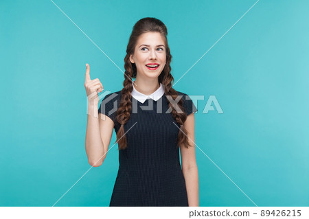 Happiness woman have a idea. Indoor, studio shot on blue background 89426215