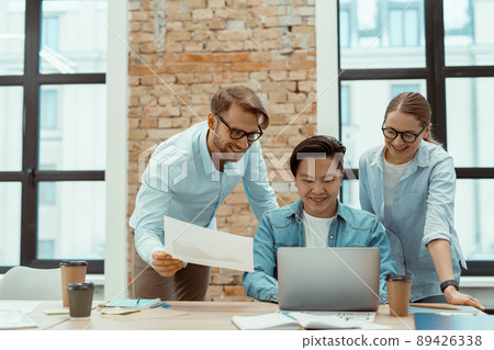 Business team working on laptop in modern office Business team working on laptop in modern office 89426338