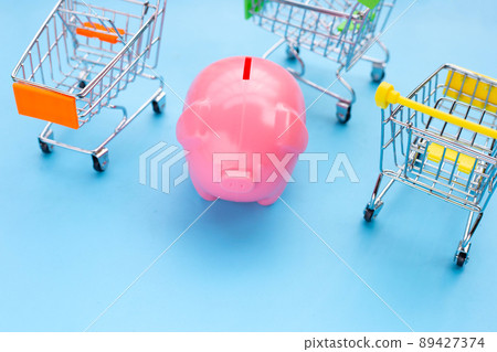 Pink piggy bank with shopping cart Pink piggy bank with shopping cart 89427374