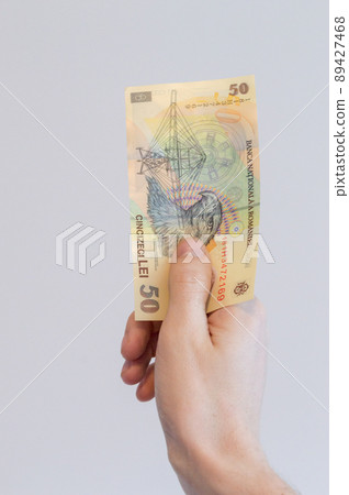 50 Romanian lei banknote in hand. 89427468