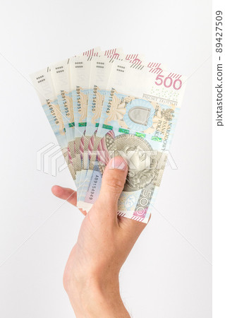 500 PLN banknotes held in hand. 89427509