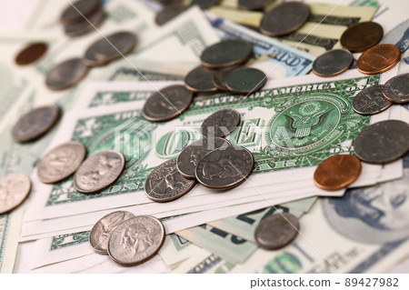 US money bills and coins close up. Big amount of american dollars on table. Business and budget US money bills and coins close up. Big amount of american dollars on table. Business and budget 89427982