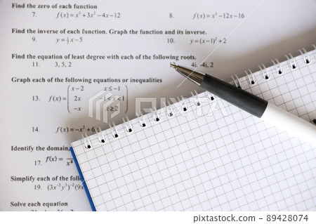 Handwriting of mathematics quadratic equation on examination, practice, quiz or test in maths class. Solving exponential equations concept. Handwriting of mathematics quadratic equation on examination, practice, quiz or test in maths class. Solving exponential equations concept. 89428074