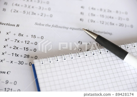 Handwriting of mathematics quadratic equation on examination, practice, quiz or test in maths class. Solving exponential equations concept. Handwriting of mathematics quadratic equation on examination, practice, quiz or test in maths class. Solving exponential equations concept. 89428174