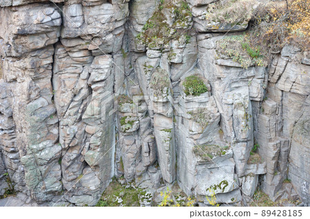Light coarse natural rock stone background. Mining cliff rough front surface. Big limestone stack backdrop. Heavy grunge damaged granite block texture Light coarse natural rock stone background. Mining cliff rough front surface. Big limestone stack backdrop. Heavy grunge damaged granite block texture 89428185