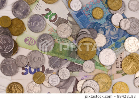 Ukrainian money bills and coins close up. Big amount of hryvnia bills and small coins on table. Business and investment Ukrainian money bills and coins close up. Big amount of hryvnia bills and small coins on table. Business and investment 89428188