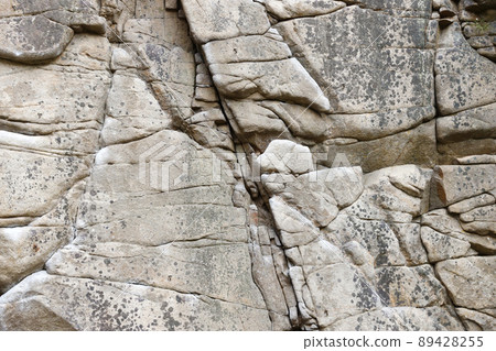 Light coarse natural rock stone background. Mining cliff rough front surface. Big limestone stack backdrop. Heavy grunge damaged granite block texture Light coarse natural rock stone background. Mining cliff rough front surface. Big limestone stack backdrop. Heavy grunge damaged granite block texture 89428255