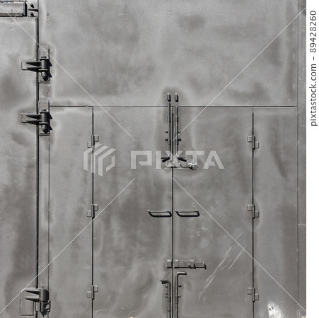 Black painted garage gates with door under the sunlight. Background texture or resource for 3d texturing 89428260