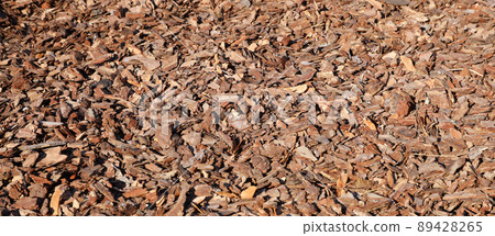 Full frame closeup of brown mulch used for gardening and landscape decoration. Texture of Birch mulch bark for garden. Closeup of wood chip path covering Full frame closeup of brown mulch used for gardening and landscape decoration. Texture of Birch mulch bark for garden. Closeup of wood chip path covering 89428265