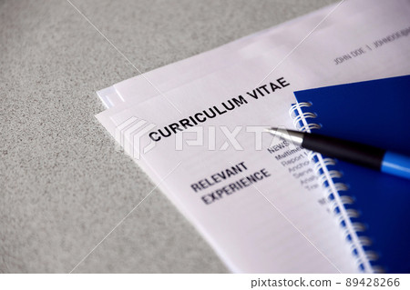 Top view of stack of office documents including resume and cv forms on the desk close to pen and notepad. Job seeking process. Hunting for workplace Top view of stack of office documents including resume and cv forms on the desk close to pen and notepad. Job seeking process. Hunting for workplace 89428266