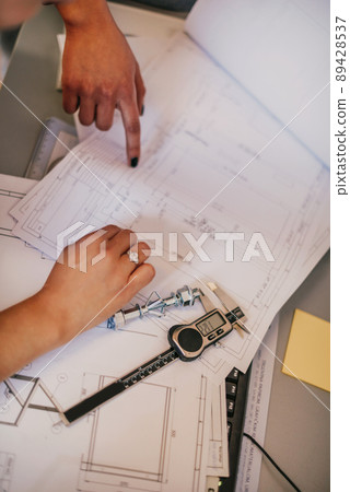 Engineer technician designing drawings mechanical parts engineering Enginemanufacturing factory Industry Industrial work project blueprints measuring bearings caliper tools Engineer technician designing drawings mechanical parts engineering Enginemanufacturing factory Industry Industrial work project blueprints measuring bearings caliper tools 89428537