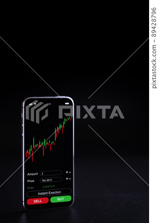 Crypto currency exchange. Pink pig bank, gold crypto currency BTC bitcoin on black background. Bitcoin trading mobile phone app. Save money investment and business finance. 89428796