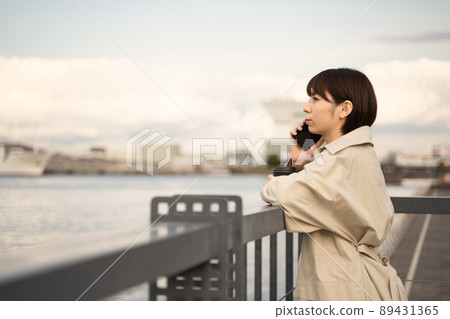 A woman talking on a smartphone A woman talking on a smartphone 89431365