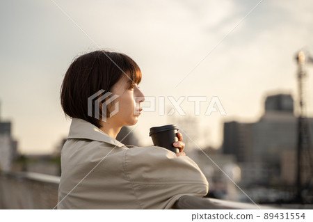 A pensive woman drinking coffee outdoors A pensive woman drinking coffee outdoors 89431554