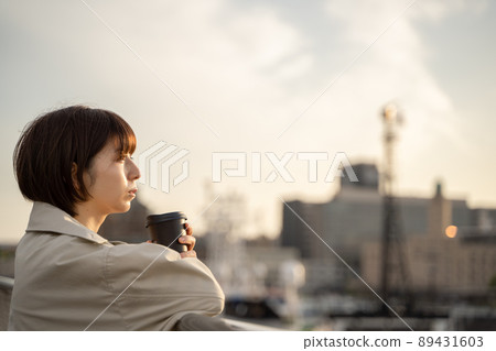 A pensive woman drinking coffee outdoors A pensive woman drinking coffee outdoors 89431603