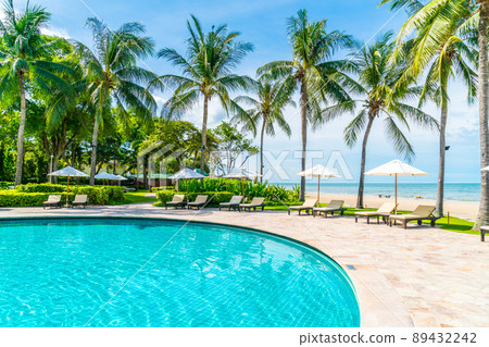 Beautiful tropical beach and sea with umbrella and chair around swimming pool in hotel resort Beautiful tropical beach and sea with umbrella and chair around swimming pool in hotel resort 89432242
